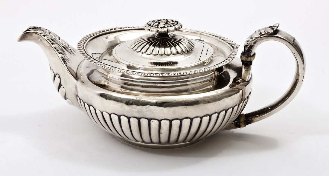 A half reeded silver Teapot,: A half reeded silver Teapot,George IV London 1821,with leaf chased handle and spout and gadroon edge, old repairs, makers mark 11" (28cms) 700g. (1)