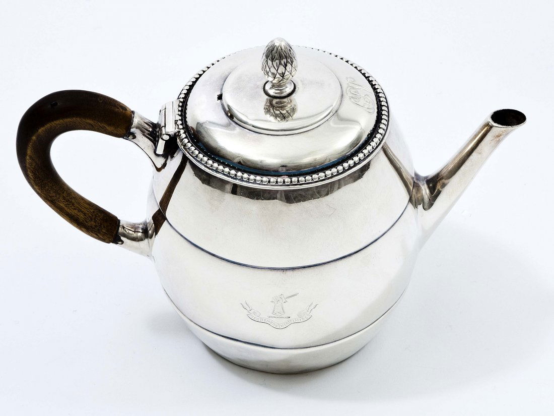 A Dutch silver barrel shaped Teapot,: A Dutch silver barrel shaped Teapot,1782 by Johannas Hermanus Lograth Amsterdam,with bead edge and pine cane finial and wooden handle, engraved with a later crest, 5"h (13cms). (1)
