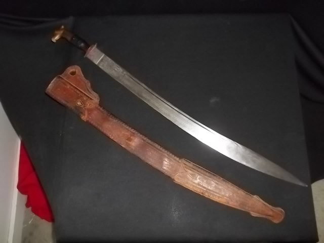 Very Old Antique Griffin Head Sword Battle Marks: Gorgeous very old griffin head handles sword with great petina and battle marks and knicks on the blade. 30 inches long with leather sheath. We are not sure of the age of this sword, but the petina ap