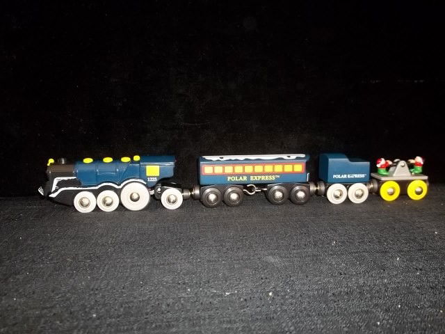 Rare Polar Express BRIO Christmas Wood Train Set: Very rare Polar Express brio train set with working engine, wooden Cab, Wooden Caboose, and two of santas elves on push cart. Very tough to find so dont miss out. Set is in nice condition.