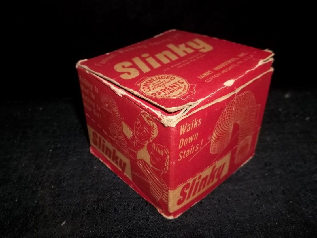 Old 1950's Slinky In Box: Old 1950's slinky in the box, box has wear.