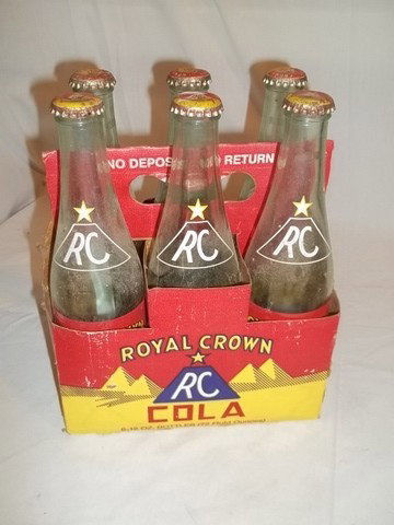 Old RC Cola Bottles In Package: 6 old RC cola bottles in the package with the tops, tops have been popped off though.