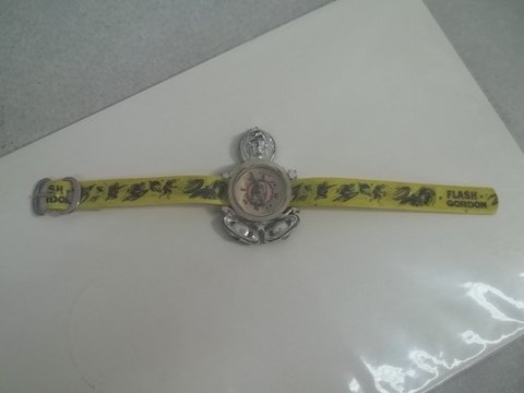 Rare 1940s Flash Gordon Wrist Watch Compass: Excellent condition with great graphics of Flash Gordon scenes all over the yellow wrist band, and more great graphics on the compass dial face itself, with die-cut plastic graphics of Flash and then 