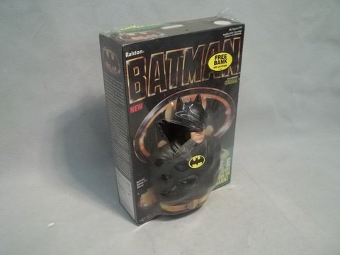 1989 Batman Movie Cereal With Bank: With Batman actor Michael Keeton-like face on bank on box front. A chew mark on the back of the box.