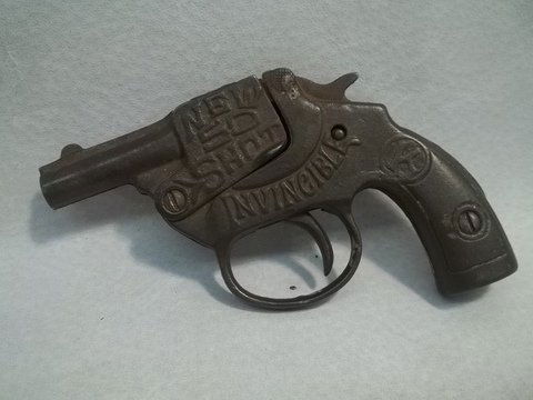 1926 Kilgor Cast Iron Cap Gun Invincible: This is a SCARE EARLY cap gun. All CAST IRON. Confirmed production in 1926. Great graphics and raised lettering on both sides. Trigger is loose but firmly in housing so does not shoot or explode caps,