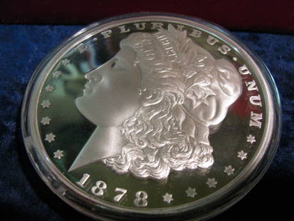 356. 1878 Large Morgan Silver Dollar Replica. One Pound: 356. 1878 Large Morgan Silver Dollar Replica. One Pound. Proof. Encapsulated. 3 1/2" diameter and 3/8" thick.