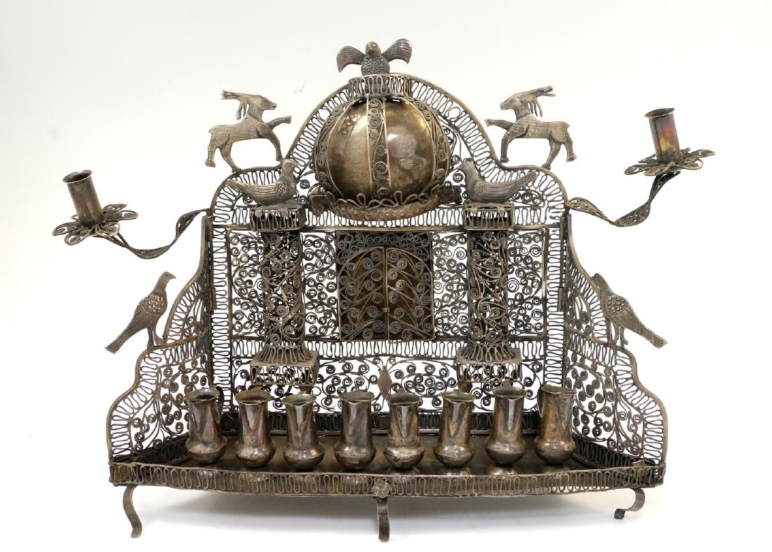 A SILVER BAAL SHEM TOV STYLE MENORAH. Modern. Crafted: A SILVER BAAL SHEM TOV STYLE MENORAH. Modern. Crafted in the style of the 19th century model. 10” tall.