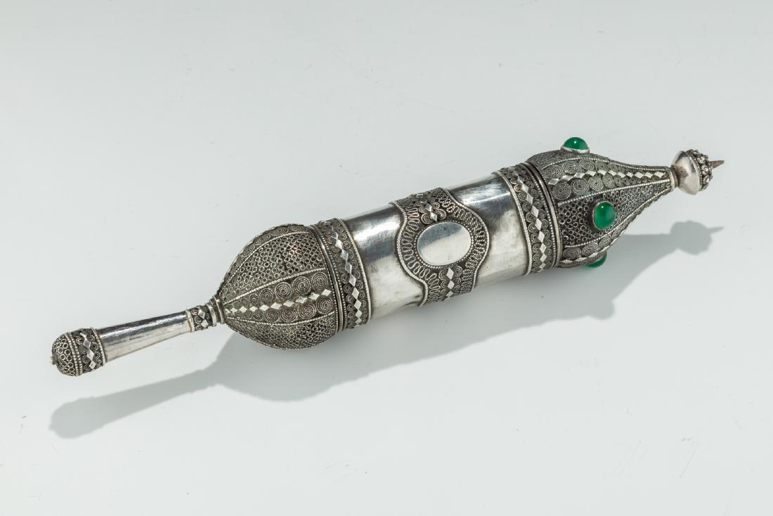 AN EARLY SILVER MEGILLAH CASE WITH ORIGINAL MEGILLAH.: AN EARLY SILVER MEGILLAH CASE WITH ORIGINAL MEGILLAH. Palestine, c 1910. The body decorated with applied wire work, filigree and cut diamond shaped applications as well and green stones. Marked in Heb
