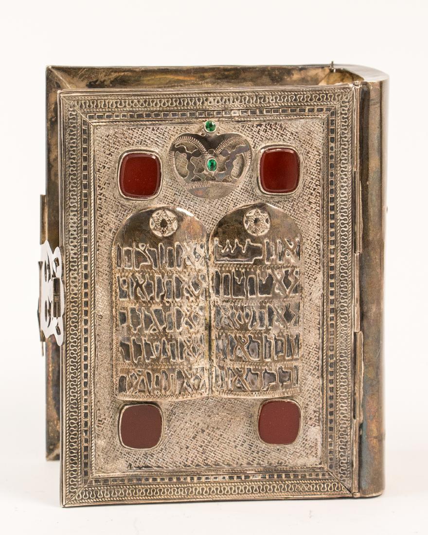 A STERLING SILVER TANACH COVER BY I.M. FAIN WITH: A STERLING SILVER TANACH COVER BY I.M. FAIN WITH ORIGINAL TANACH. Israel, c. 1960. Decorated with applied red stones and the decalogue. Inside cover had hand written fancy dedication to Samuel Rosenth