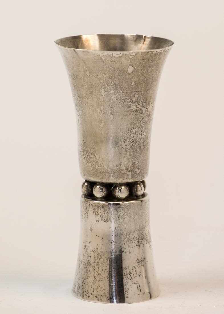 A STERLING SILVER GOBLET. Mexico, c. 1970. With one: A STERLING SILVER GOBLET. Mexico, c. 1970. With one side for a whiskey shot and one for wine. 4.2" tall.