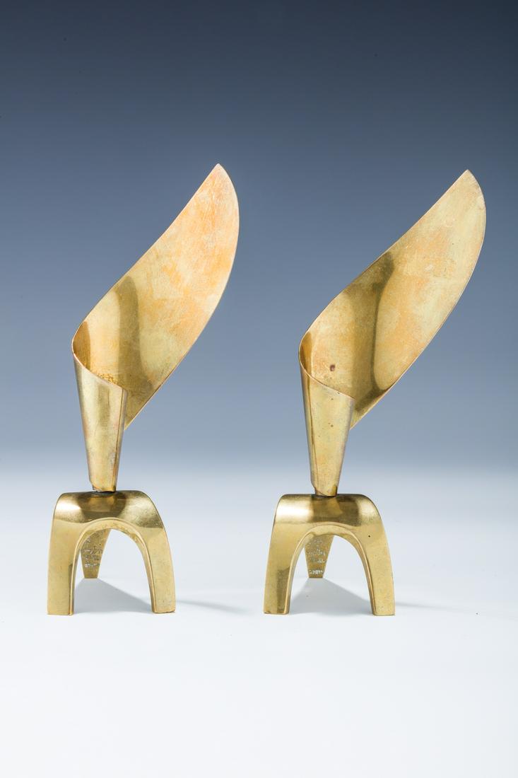 A PAIR OF BRASS CANDLESTICKS BY LUDWIG WOLPERT. Israel,: A PAIR OF BRASS CANDLESTICKS BY LUDWIG WOLPERT. Israel, c. 1950. Each on solid feet with a flame like back part. 6.8" tall.