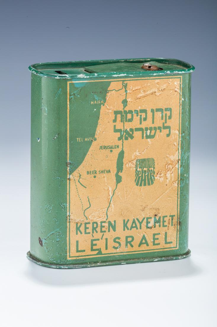 AN EARLY AND RARE JNF/KKL CHARITY CONTAINER. U.S.A., c.: AN EARLY AND RARE JNF/KKL CHARITY CONTAINER. U.S.A., c. 1938. Traditional in shape. With a unique front design featuring KKL insignia and map of Israel. With a rare opening on the lid. 4.5” tall.