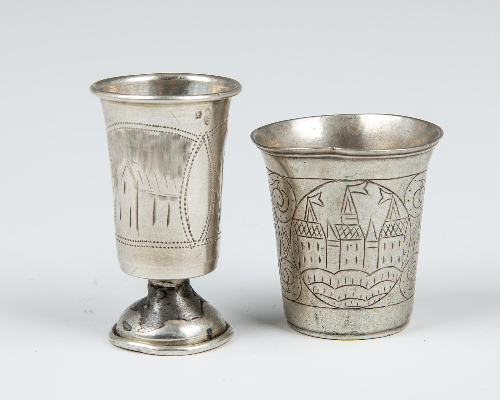 57. TWO RUSSIAN/POLISH SOLID SILVER CUPS. 19th century.: 57. TWO RUSSIAN/POLISH SOLID SILVER CUPS. 19th century. The first is footed and marked 84. The second is in beaker form and marked “12”.