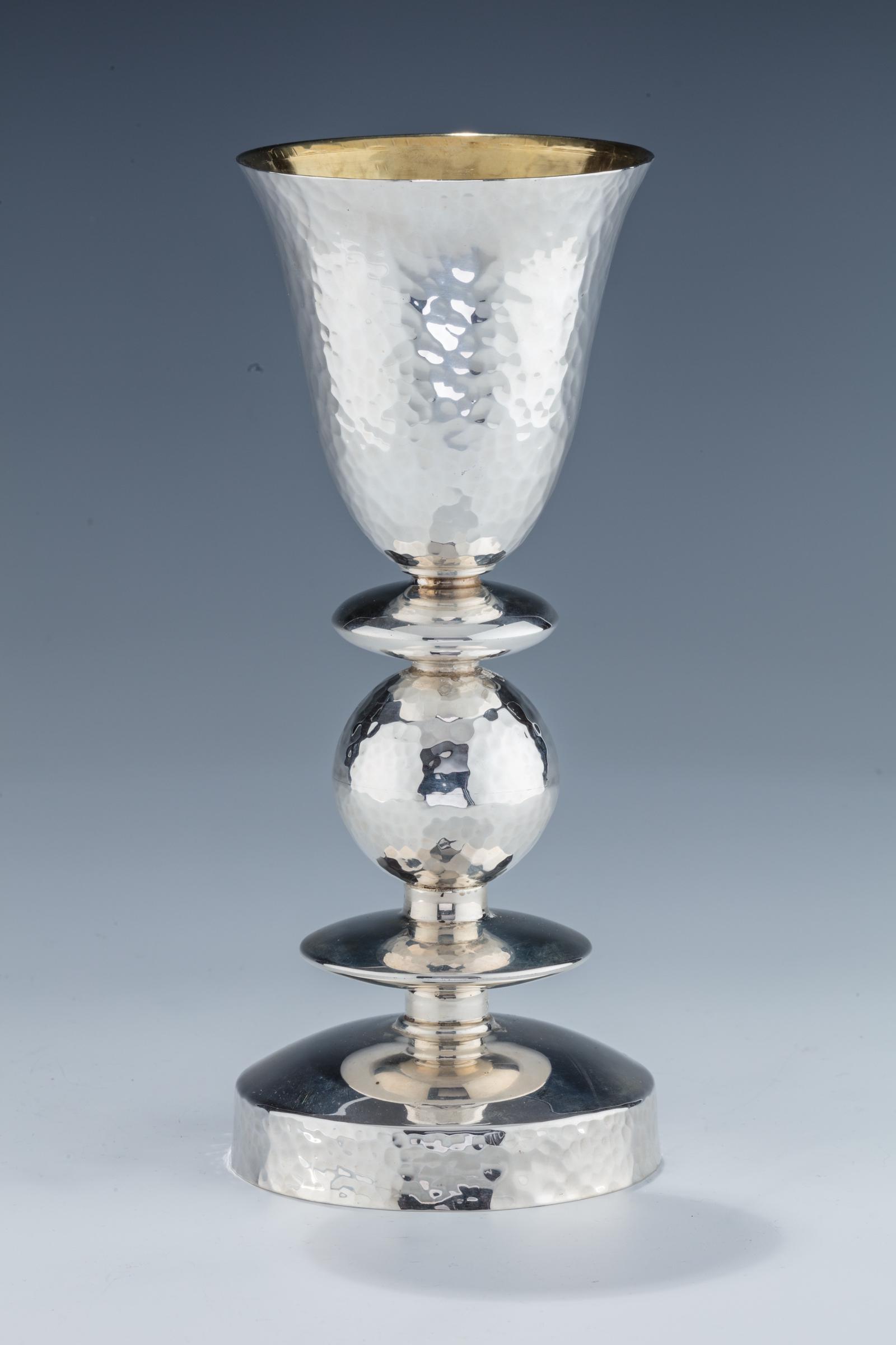 A MONUMENTAL STERLING SILVER KIDDUSH CUP BY BIER.: A MONUMENTAL STERLING SILVER KIDDUSH CUP BY BIER. Israel, modern. Hand hammered in the style of Shabi. 9.2” tall.