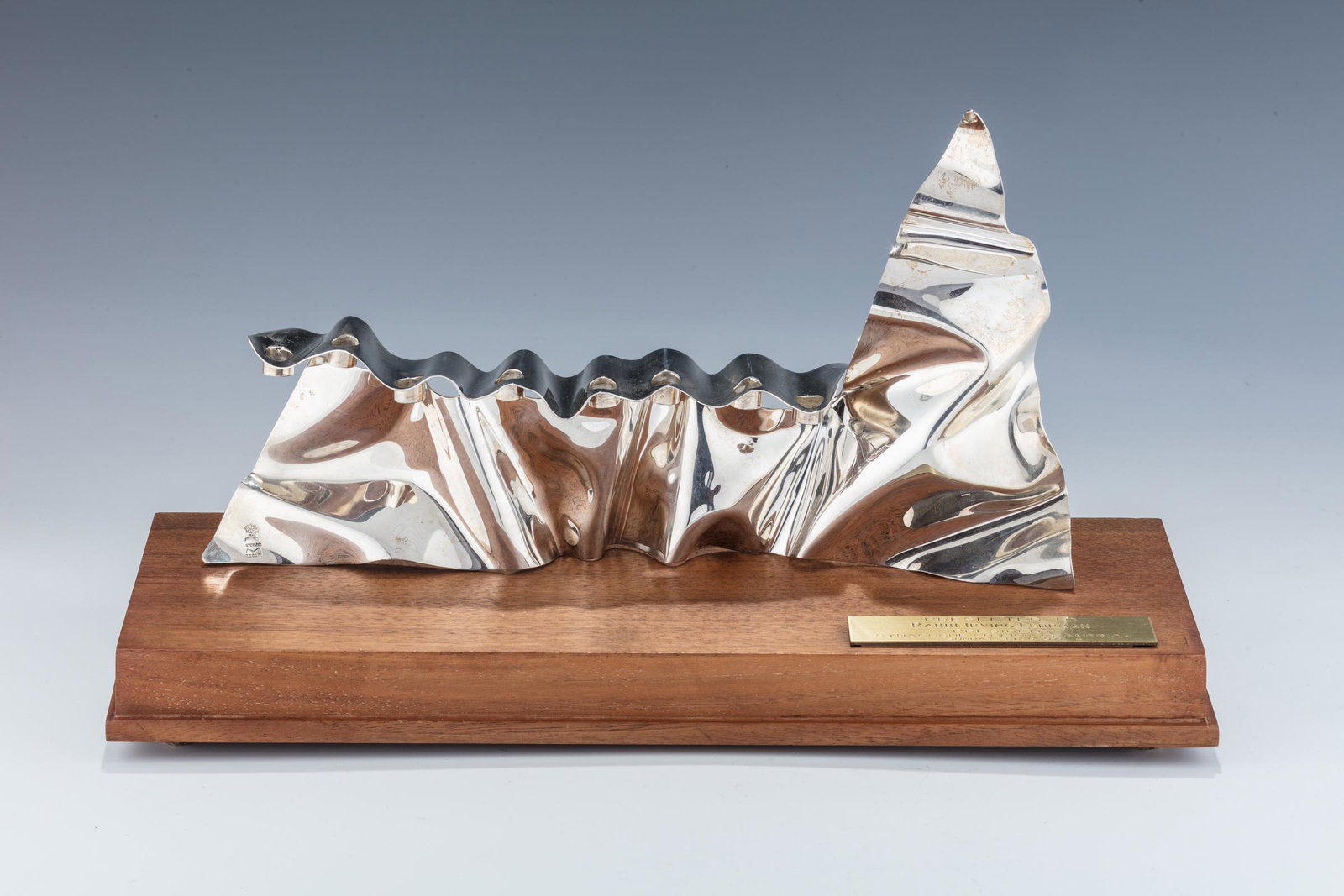 A STERLING SILVER MENORAH BY MOSHE ZABARI New York 1967: 145. A STERLING SILVER MENORAH BY MOSHE ZABARI. New York, c. 1967. Moshe Zabari, Israeli / American (Born 1935 - ). One of seven known in the shape of a mountain. 6 3/4", W. 11 3/4". Total weight of 1