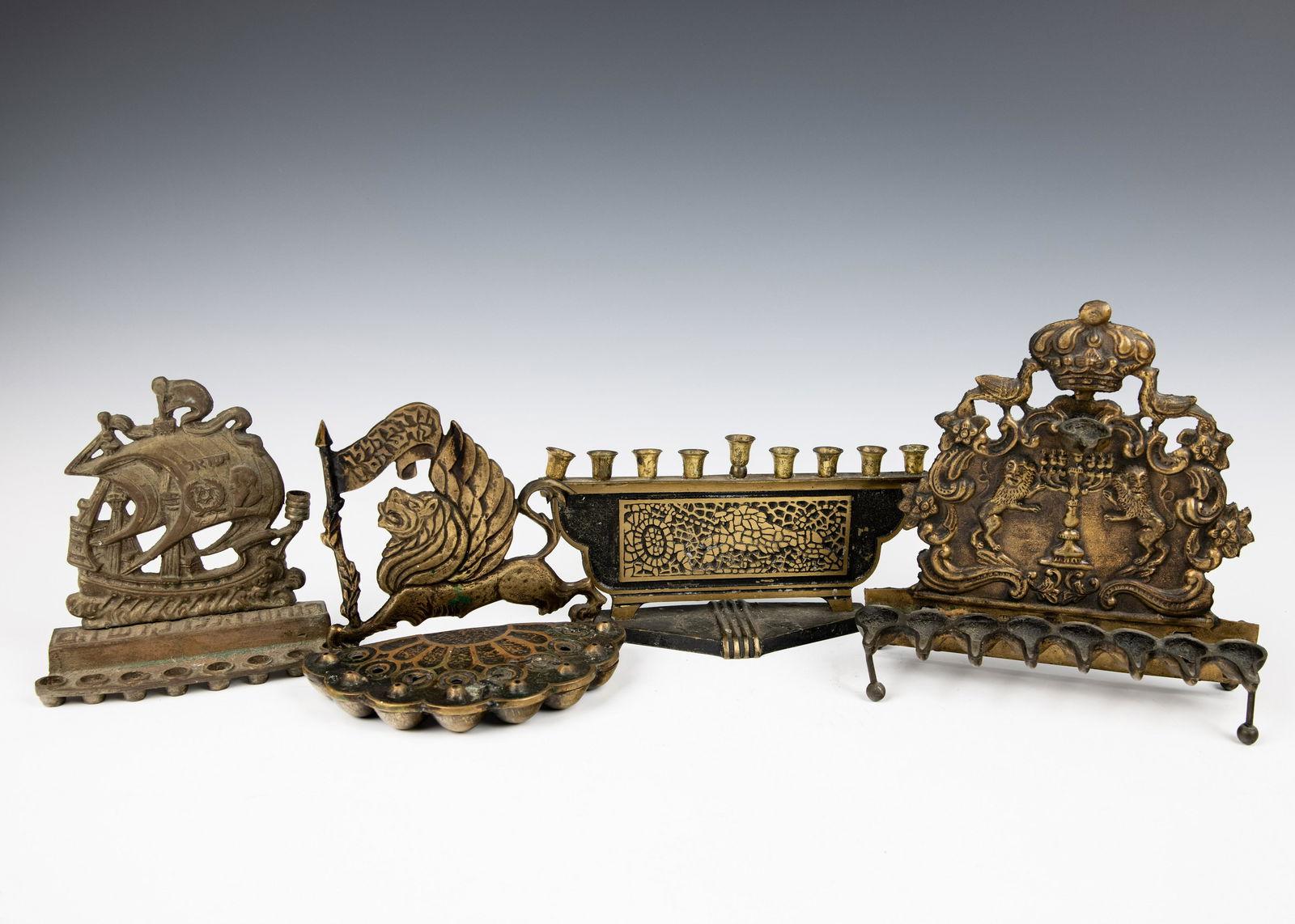 A GROUP OF FOUR BRASS HANUKKAH LAMPS (1 of 1)