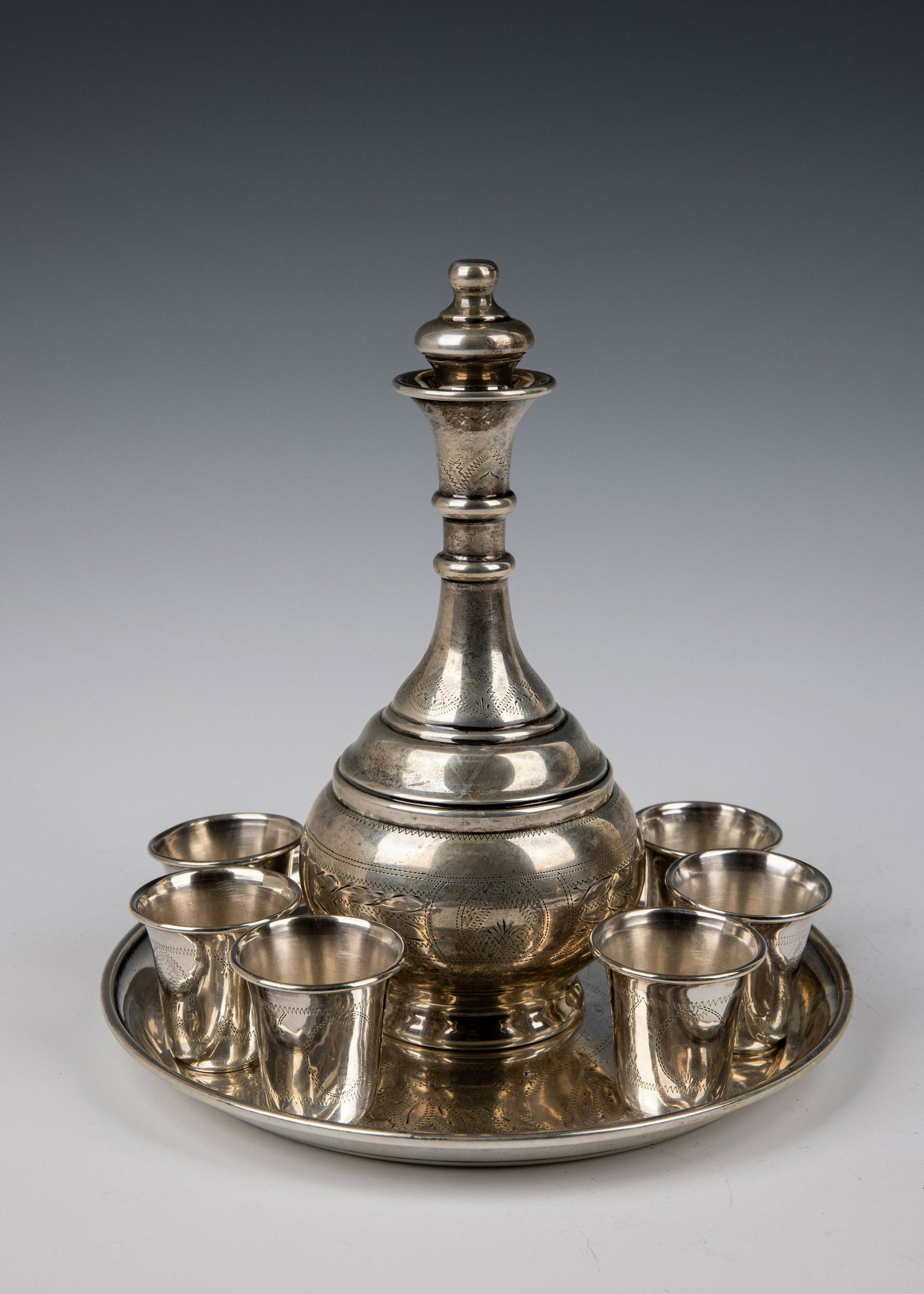 A SILVER WINE SET: 201. A SILVER WINE SET. American, 19th century. Consisting of a bottle with a stopper, a tray and six cups.