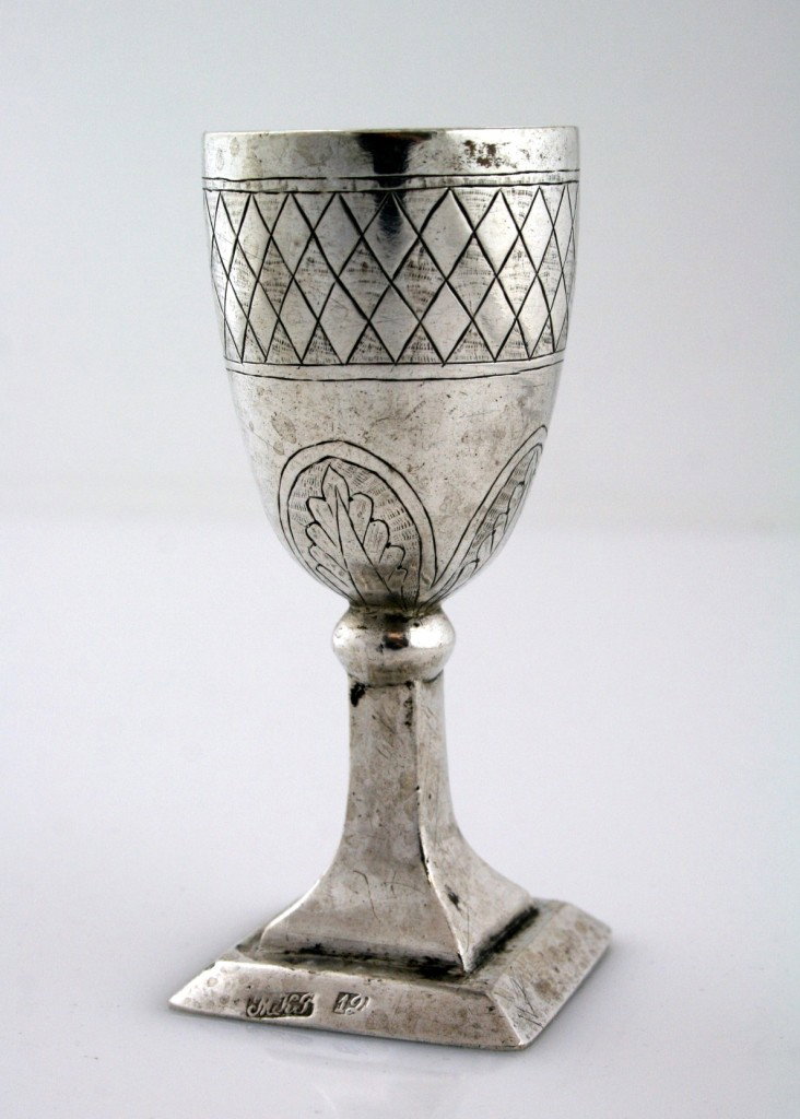 A BRESLOV STYLE KIDDUSH GOBLET. Ukraine or Poland, : A BRESLOV STYLE KIDDUSH GOBLET. Ukraine or Poland, c. 1830. On square base, with octagonal stem that connects to upper portion decorated in checkerboard design. Purchased at Sotheby's Tel Aviv April 1
