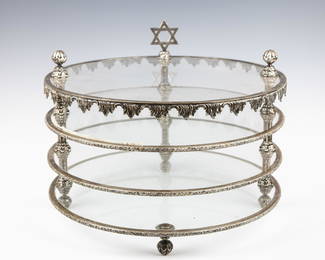 A LARGE THREE TIER MATZAH HOLDER. Vienna, c. 1900. On three supports. The rim consists of fancy