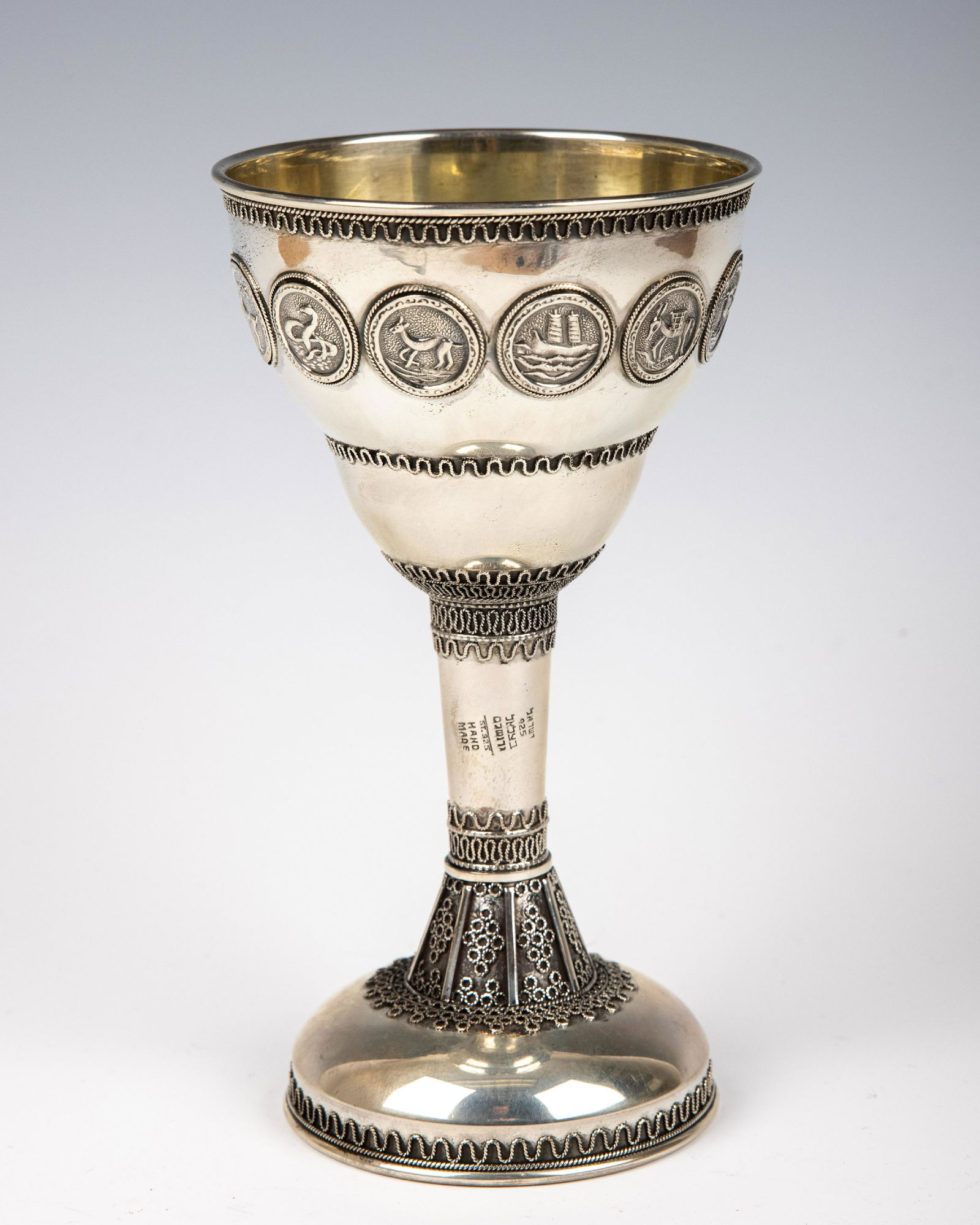 A LARGE STERLING SILVER KIDDUSH GOBLET BY THE BEZALEL SCHOOL. Jerusalem, 20th century. On a round (1 of 1)
