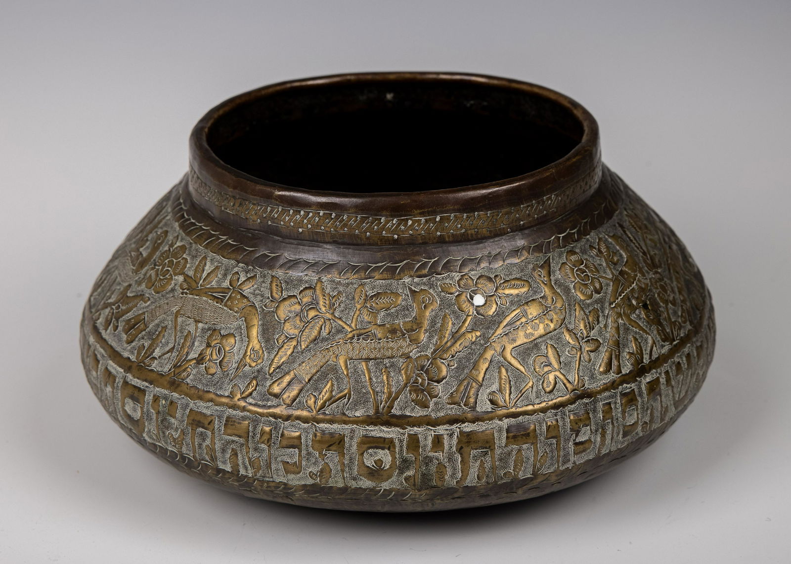 A LARGE COPPER BOWL. Israeli by Persian artisans, c. 1950. Hand chased with Hebrew letters along the (1 of 1)