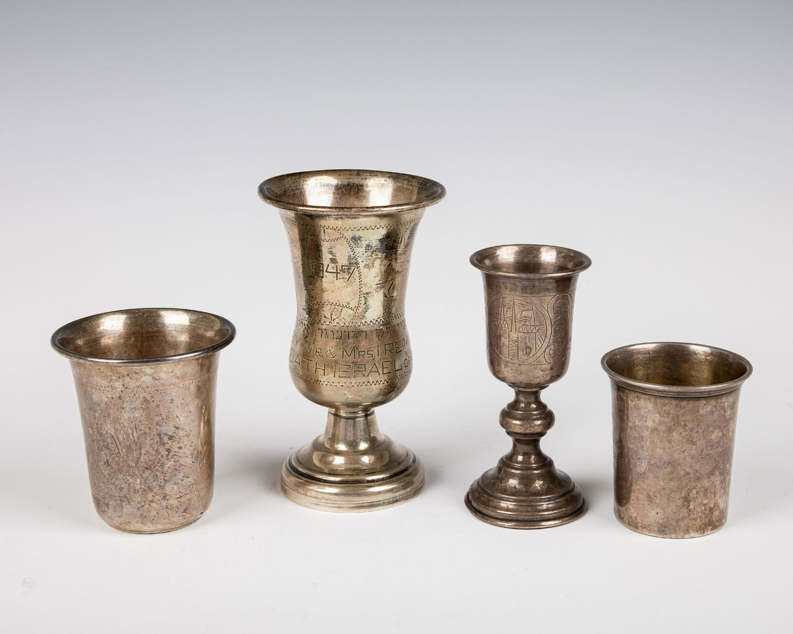 A GROUP OF FOUR SILVER KIDDUSH CUPS. USA and Russia. Each engraved with typical period design. 9.1 (1 of 1)