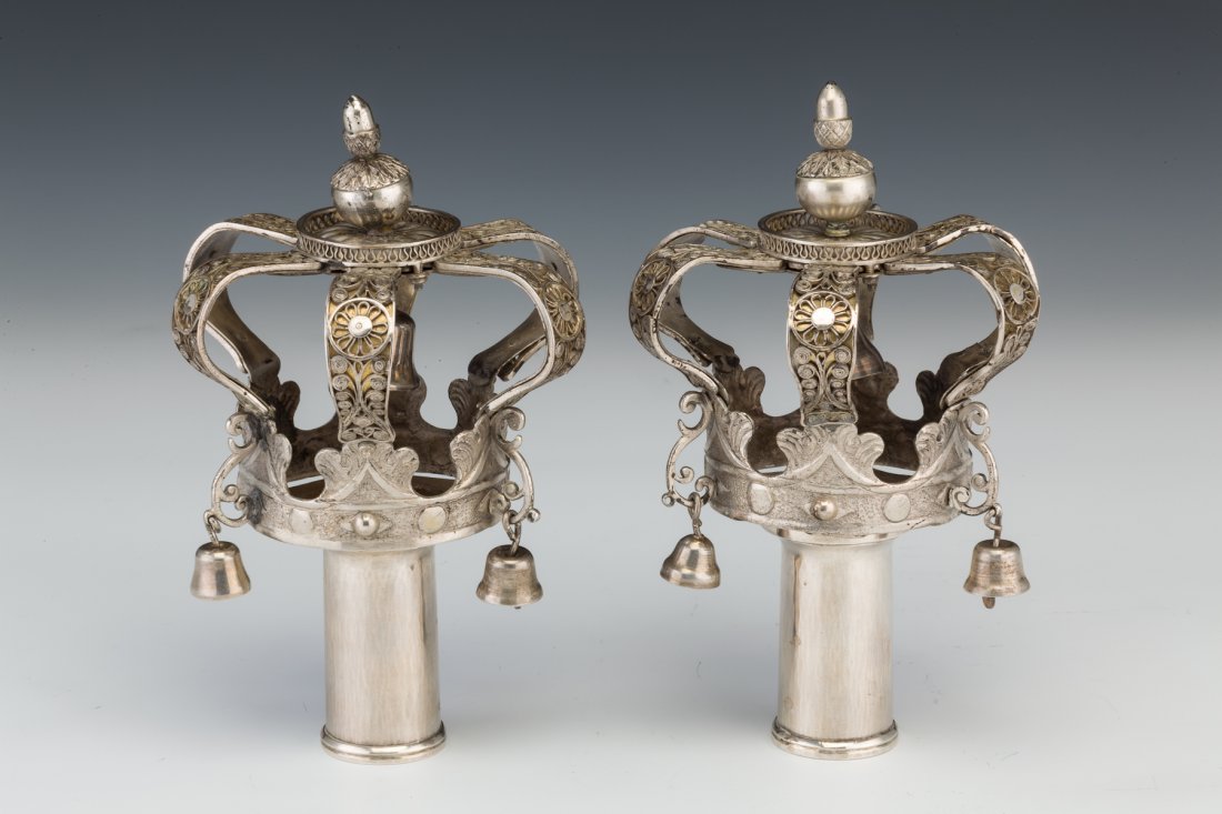 A PAIR OF SILVER TORAH FINIALS. Poland, 19th c: A PAIR OF SILVER TORAH FINIALS. Poland, 19th century. On small round staves. Decorated with bells, filigree on solid silver ribs and acorn finial. 7” tall.
