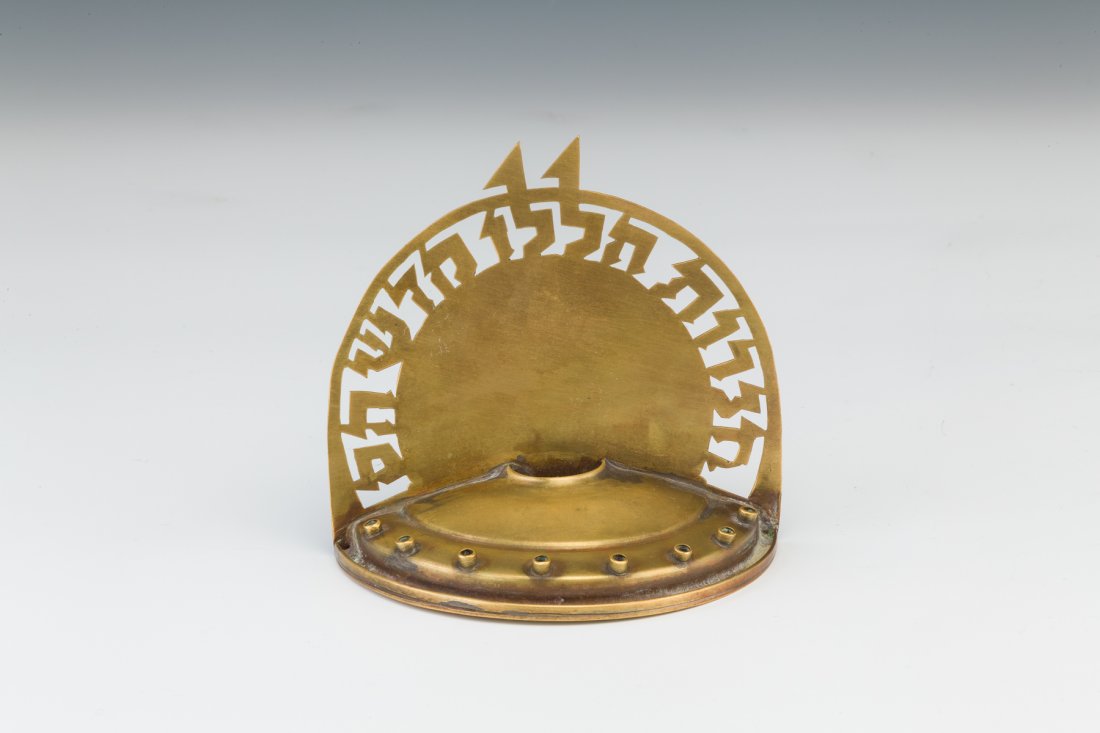 A BRASS MENORAH LUDWIG WOLPERT. Jerusalem,1940: A BRASS MENORAH BY LUDWIG WOLPERT. Jerusalem, c. 1940. Marked with a rare marking of Wolpert in Hebrew as well as Jerusalem, which puts this menorah from 1935 until he was invited to work in the Jewis