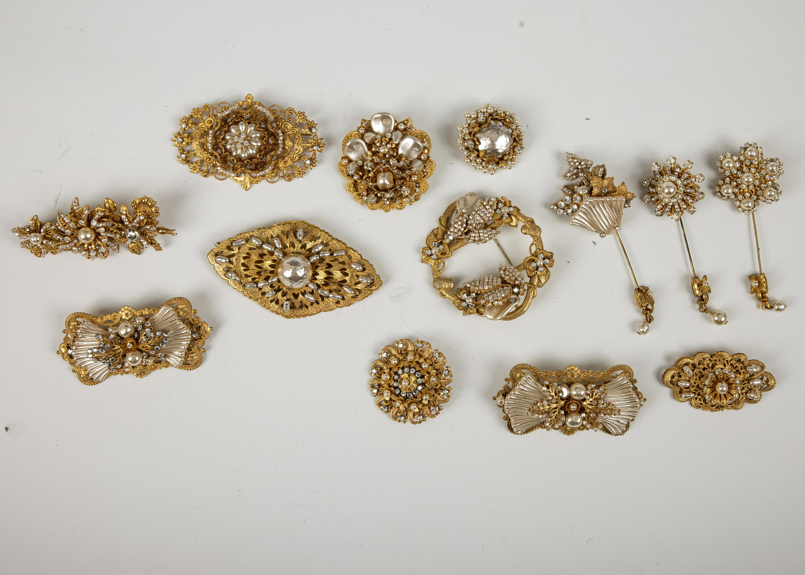 A GROUP OF 13 BROOCHES BY MIRIAM HASKELL: Various sizes and designs. Excellent condition. From a private Brooklyn estate