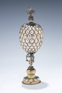 A LARGE GILDED SILVER COVERED GOBLET. Germany, 1901. On around base with an overall pineapple motif.: A LARGE GILDED SILVER COVERED GOBLET. Germany, 1901. On around base with an overall pineapple motif. Inscribed in German with a dedication dated 1901. 11” tall.