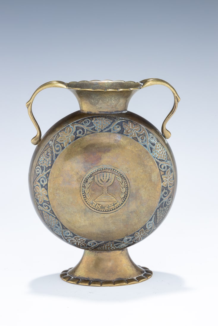 A BRASS VASE BY THE BEZALEL SCHOOL. Jerusalem, c. 1929. On an oval base with acid etched designs and (1 of 6)