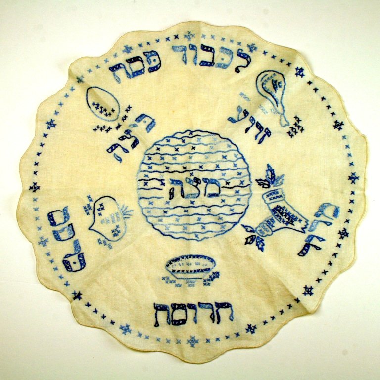 A NEEDLEPOINT MATZAH COVER. United States, c. 1950: A NEEDLEPOINT MATZAH COVER. United States, c. 1950. Sewn in blue thread on white background. 16” wide.