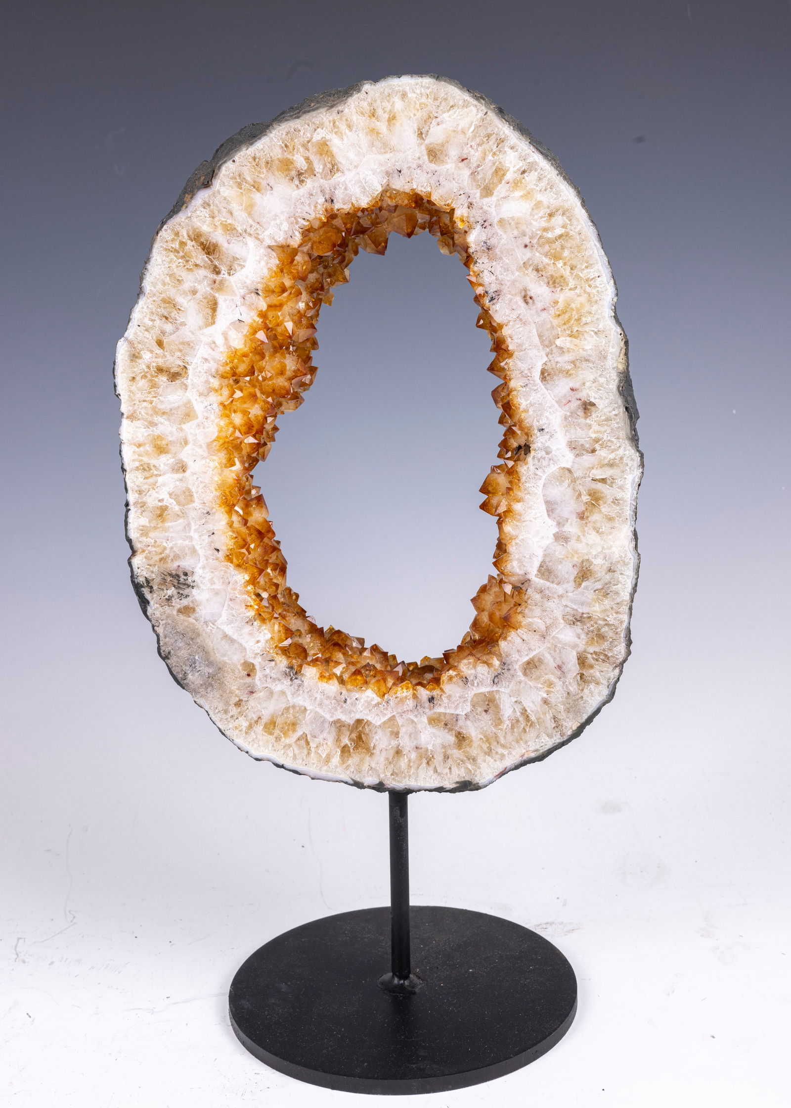 A LARGE CITRINE GEODE RING ON A BLACK METAL DISPLAY STAND (1 of 1)