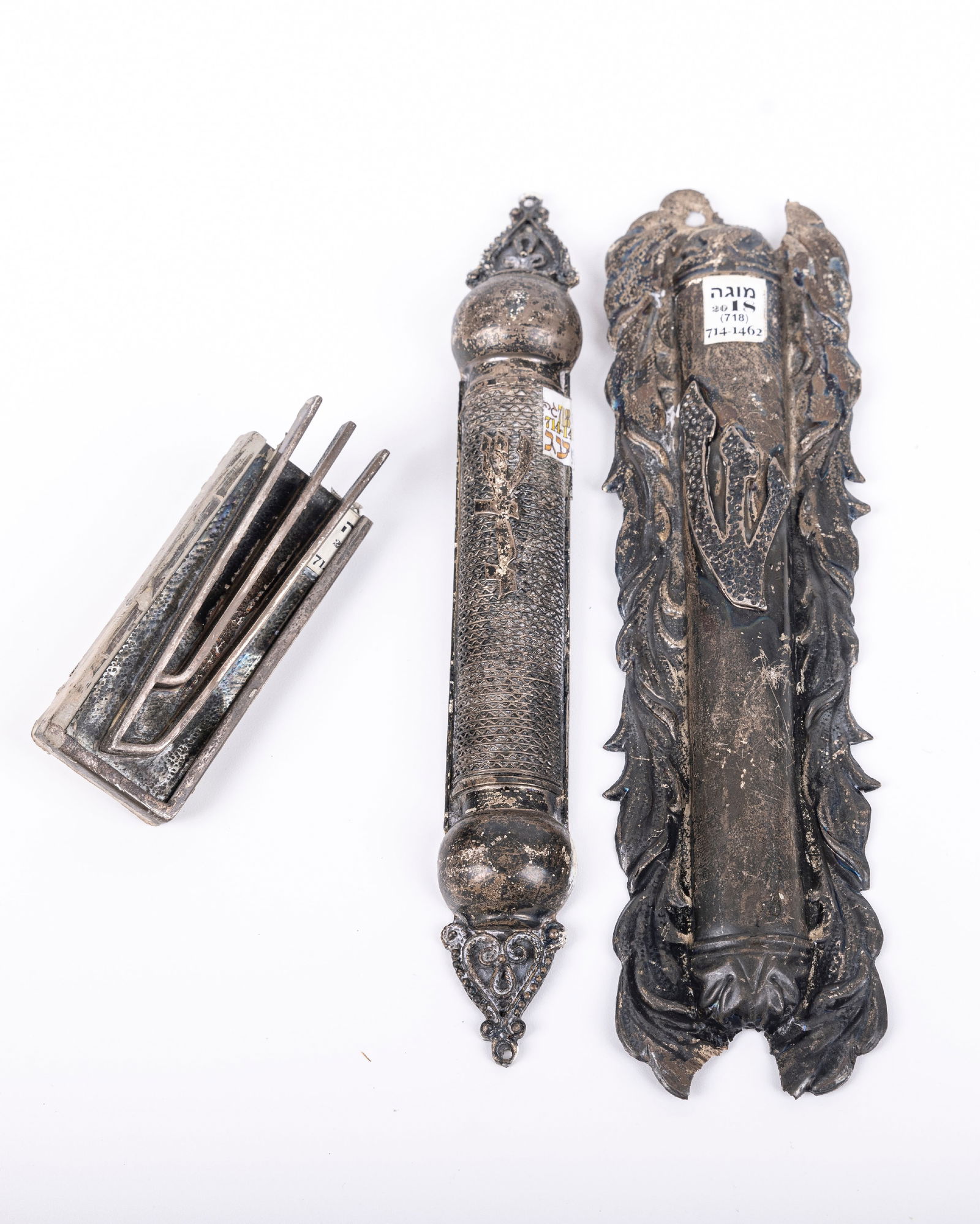 A GROUP OF THREE STERLING SILVER MEZUZAH COVERS. Israel, 20th century. Sizes vary from 7" to 3". (1 of 1)