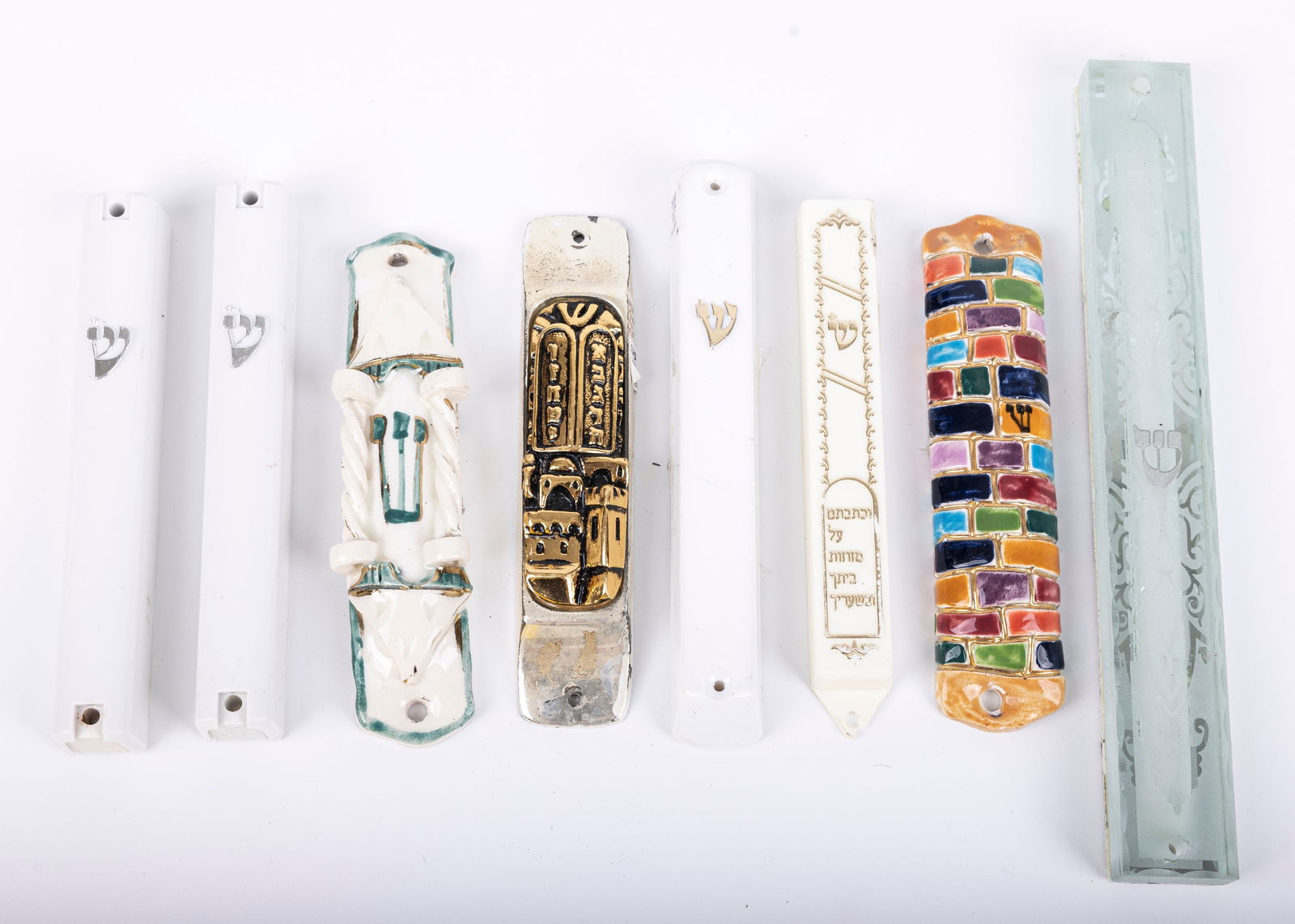 A GROUP OF SEVEN MEZUZAH COVERS. Israel, 20th century. Sizes vary from 7" to 5". (1 of 1)