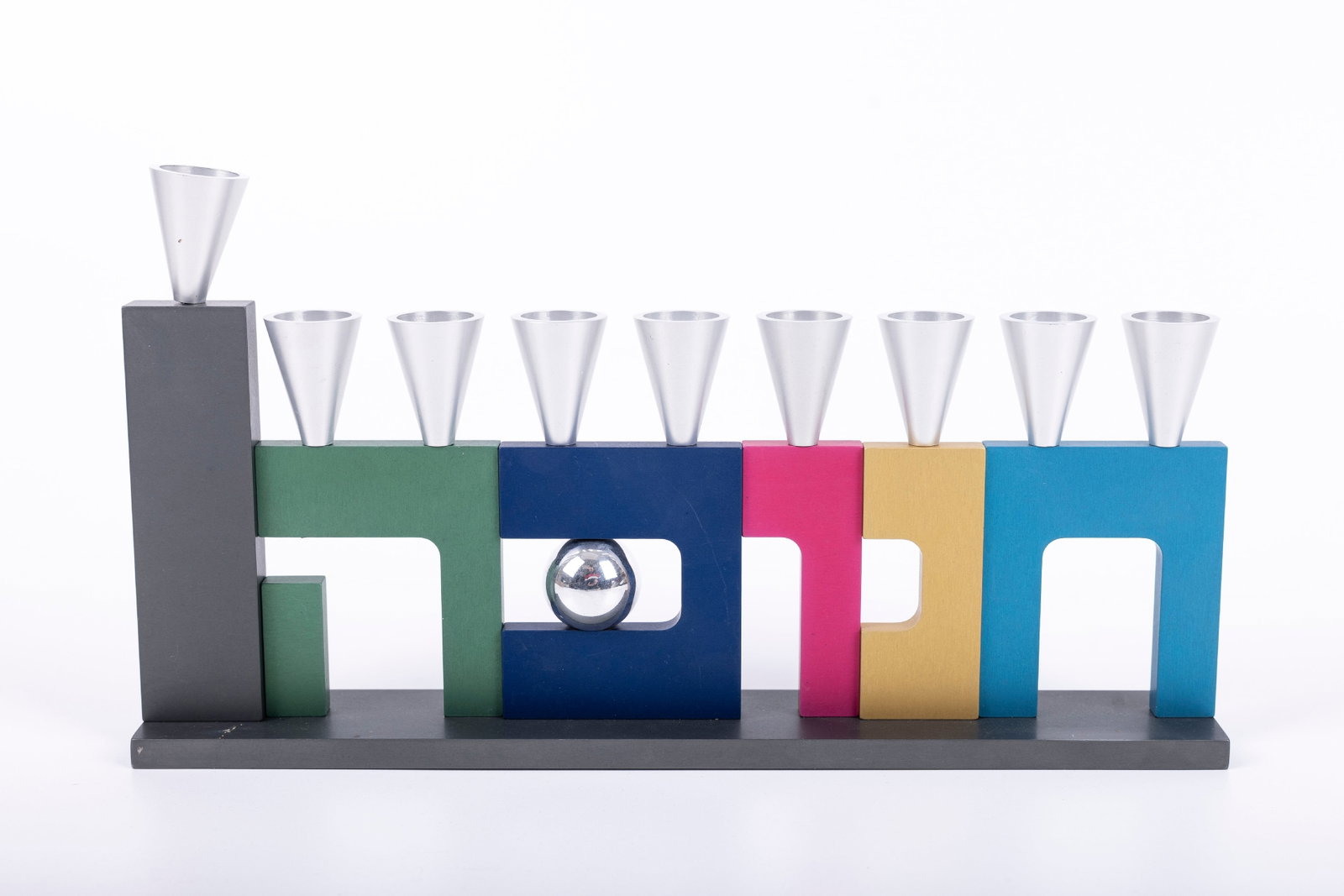 A COLORFUL ANODIZED ALUMINUM MENORAH. Israel, modern. Spelling out Hanukkah in Hebrew. 10.6" long.: A COLORFUL ANODIZED ALUMINUM MENORAH. Israel, modern. Spelling out Hanukkah in Hebrew. 10.6" long.