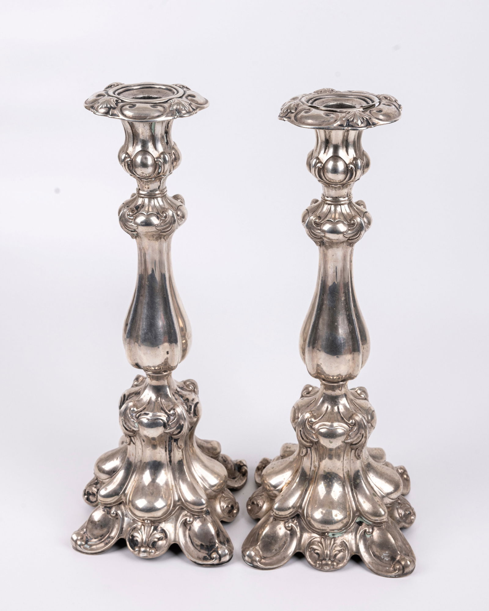 A PAIR OF SILVER CANDLESTICKS. Germany, c. 1890. The bases are embossed with floral designs. Some (1 of 6)