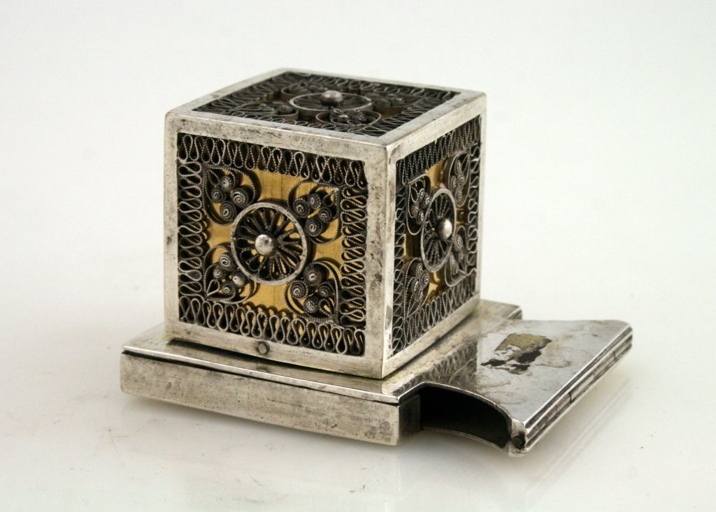 A SILVER TEFILLIN CASE. Ukraine, c. 1820.: A SILVER TEFILLIN CASE. Ukraine, c. 1820. Gilded base. Jand spun filigree decoration. Marked 12 and Goldman. 3” tall.