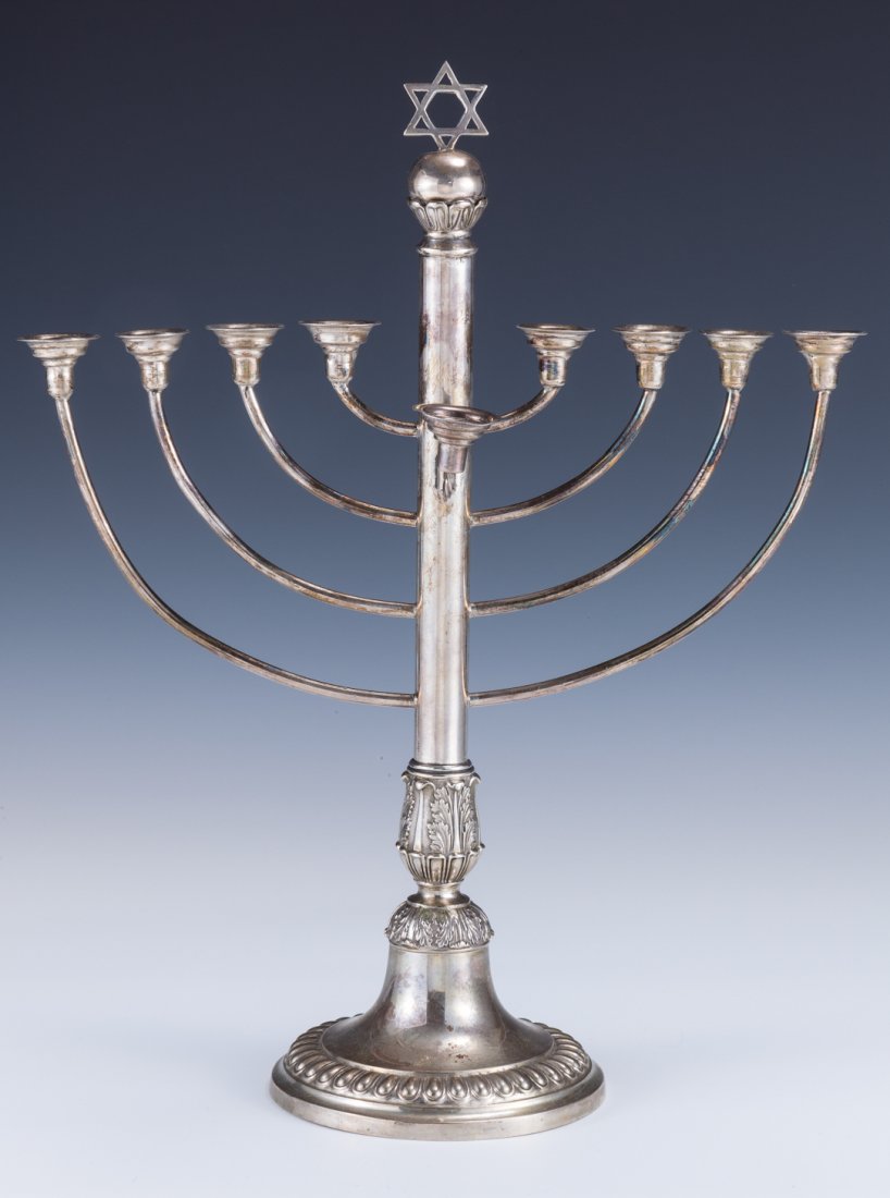 A LARGE SILVER MENORAH. Germany, c. 1890.: A LARGE SILVER MENORAH. Germany, c. 1890. On round chased base. With eight arms and a Star of David finial. 14.5” tall.