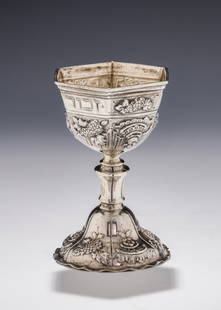 A SILVER KIDDUSH CUP. Germany, c.1890. On a round crimped base with a knobbed stem that connects to: A SILVER KIDDUSH CUP. Germany, c.1890. On a round crimped base with a knobbed stem that connects to a six sided upper portion that is engraved with the biblical commandment to honor the