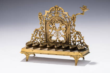 A PARCEL GILT HANUKKAH LAMP. Vienna, c.1910. On four supports that attach to a rectangular base. The (1 of 4)