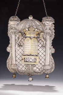 A LARGE SILVER TORAH SHIELD. Berlin, c.1840. Decorated with two Corinthian columns, a decalogue, two: A LARGE SILVER TORAH SHIELD. Berlin, c.1840. Decorated with two Corinthian columns, a decalogue, two lions, two flower filled baskets, a crown and a portion