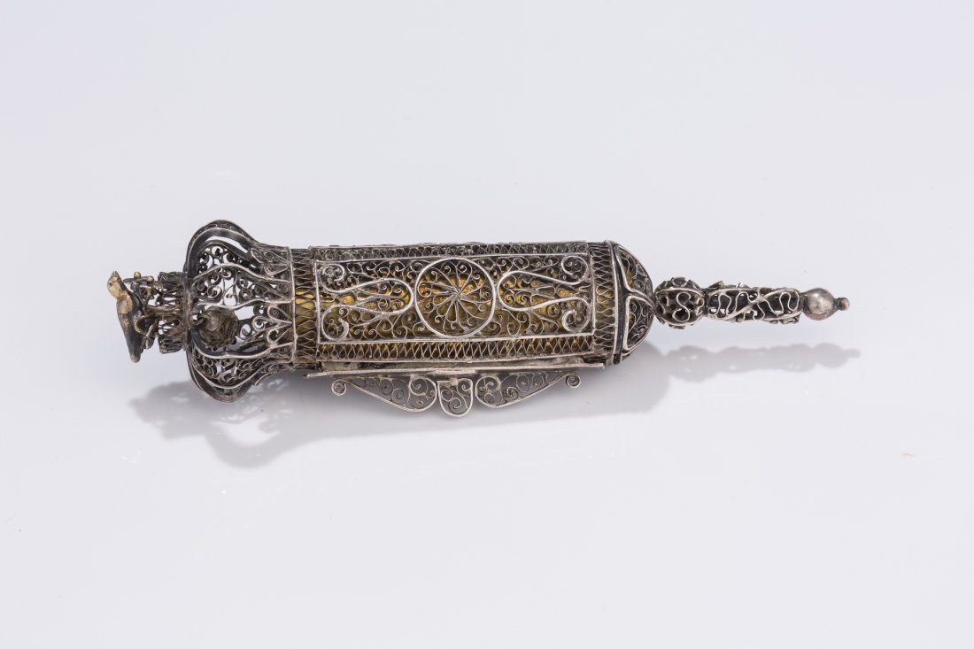 A MINIATURE SILVER MEGILLAH CASE WITH ORIGINAL MEGI: A MINIATURE SILVER MEGILLAH CASE WITH ORIGINAL MEGILLAH. Russian, 1846. Completely made of filigree. With original megillah. 5.5” long.