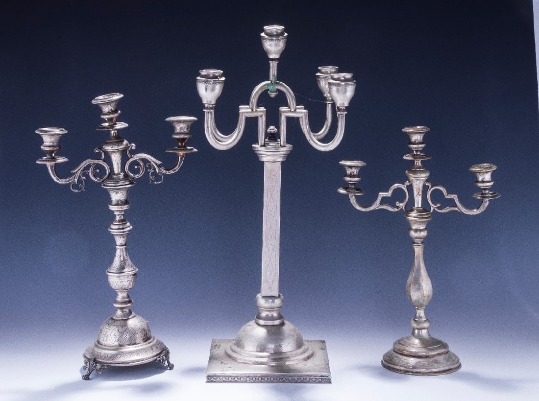 A COLLECTION OF EIGHT SABBATH CANDELABRAS.: Vienna and Germany, late 19th and early 20th centuries. All on round bases with engine turned bright cut designs. Various heights and conditions. Total weight 192 troy ounces. Estimate $3,000 - 5,000