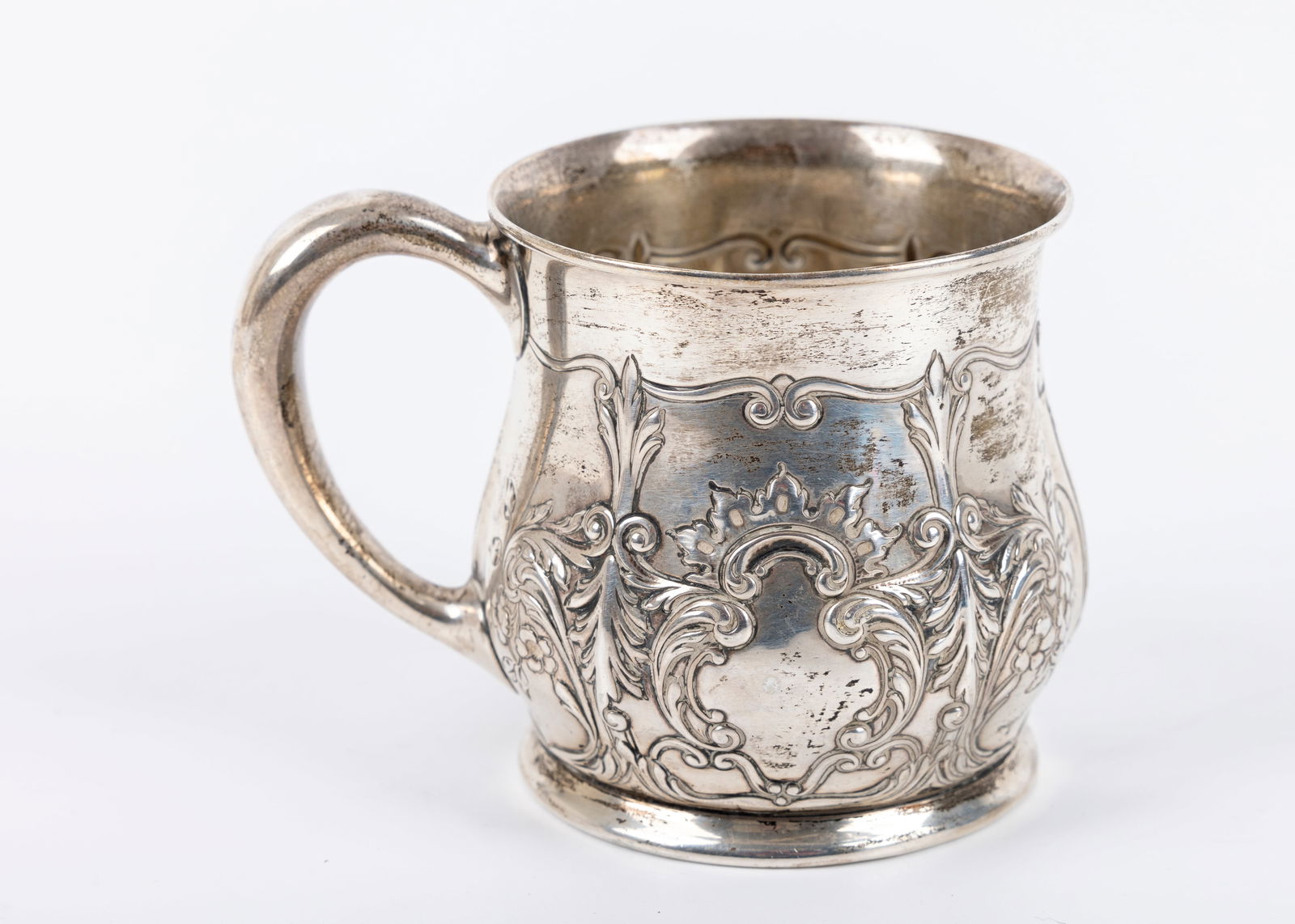 AN EARLY BABY CUP BY GORHAM. American: AN EARLY BABY CUP BY GORHAM. American, c. 1900. With handle and scrolling design. 3.59 troy ounces and 3” tall. Estimate $90 - 120