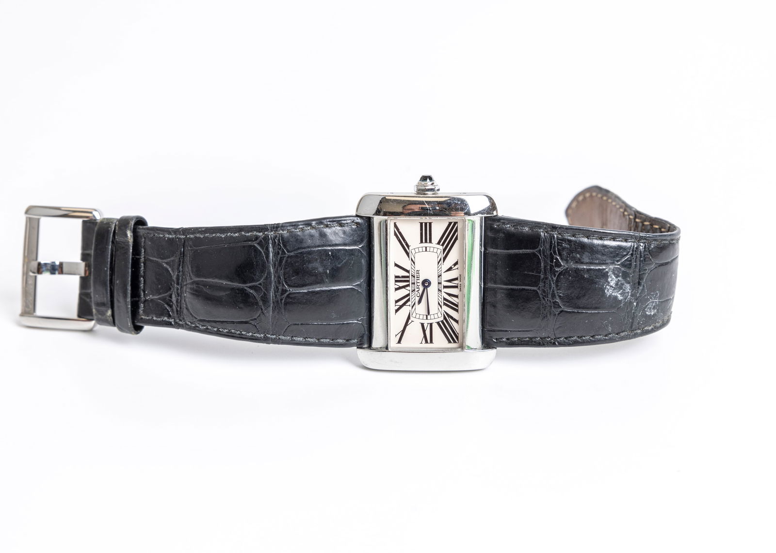 A CARTIER STAINLESS STEEL WRISTWATCH. With a worn tapered black cartier band and box. Marked CARTIER: A CARTIER STAINLESS STEEL WRISTWATCH. In original box and book. Box (only) seems to have some mold. With a worn tapered black cartier band. Marked CARTIER WATER RESISTANT STAINLESS STEEL 106908 CE 260