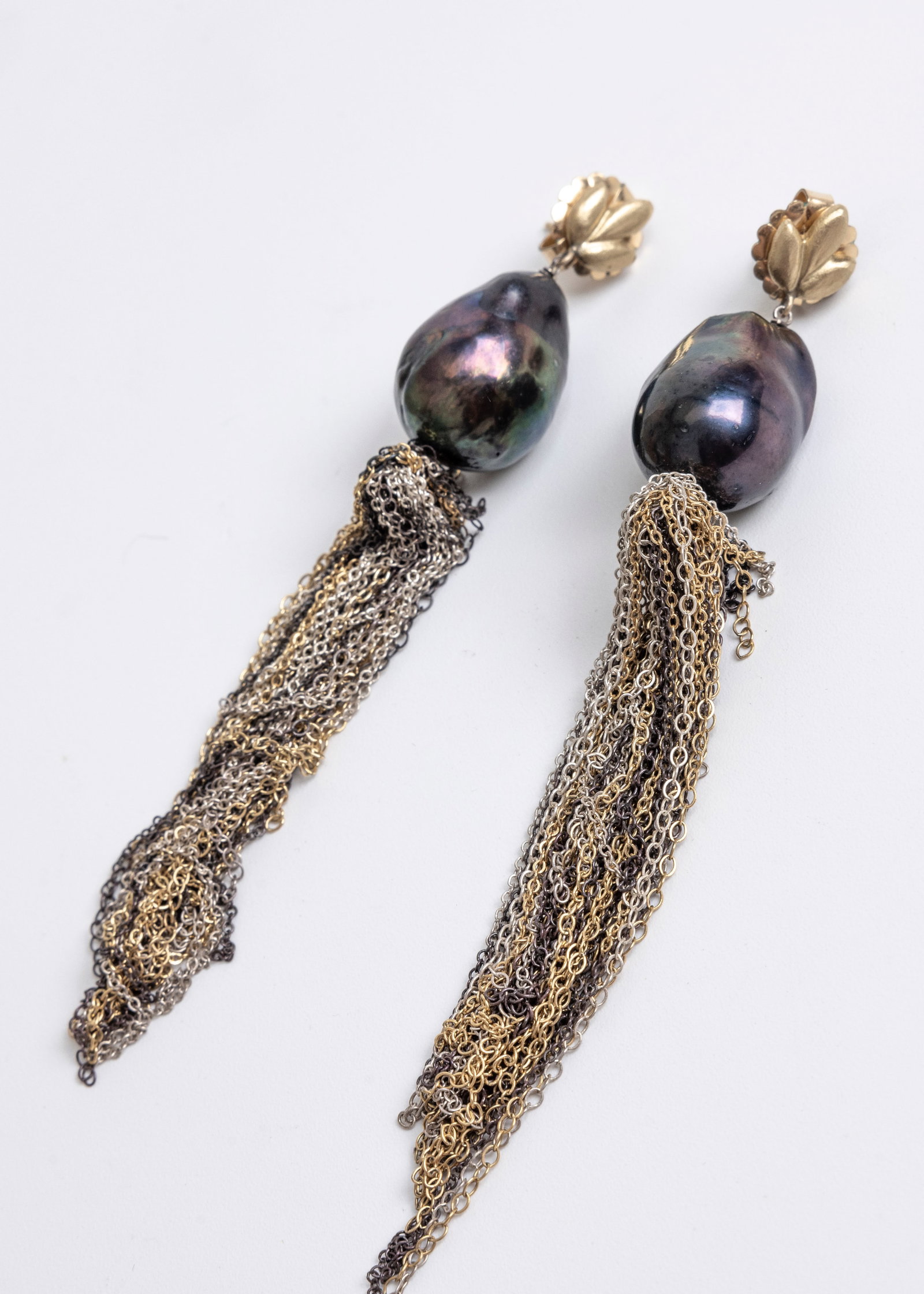 A PAIR OF BAROQUE BLACK 20 X 14 MM TAHITIAN PEARL EARRINGS. With yellow gold pierced tops and suspen: A PAIR OF BAROQUE BLACK 20 X 14 MM TAHITIAN PEARL EARRINGS. With yellow gold pierced tops and suspending multi-colored chains. Total weight 14.8 dwt. (75)