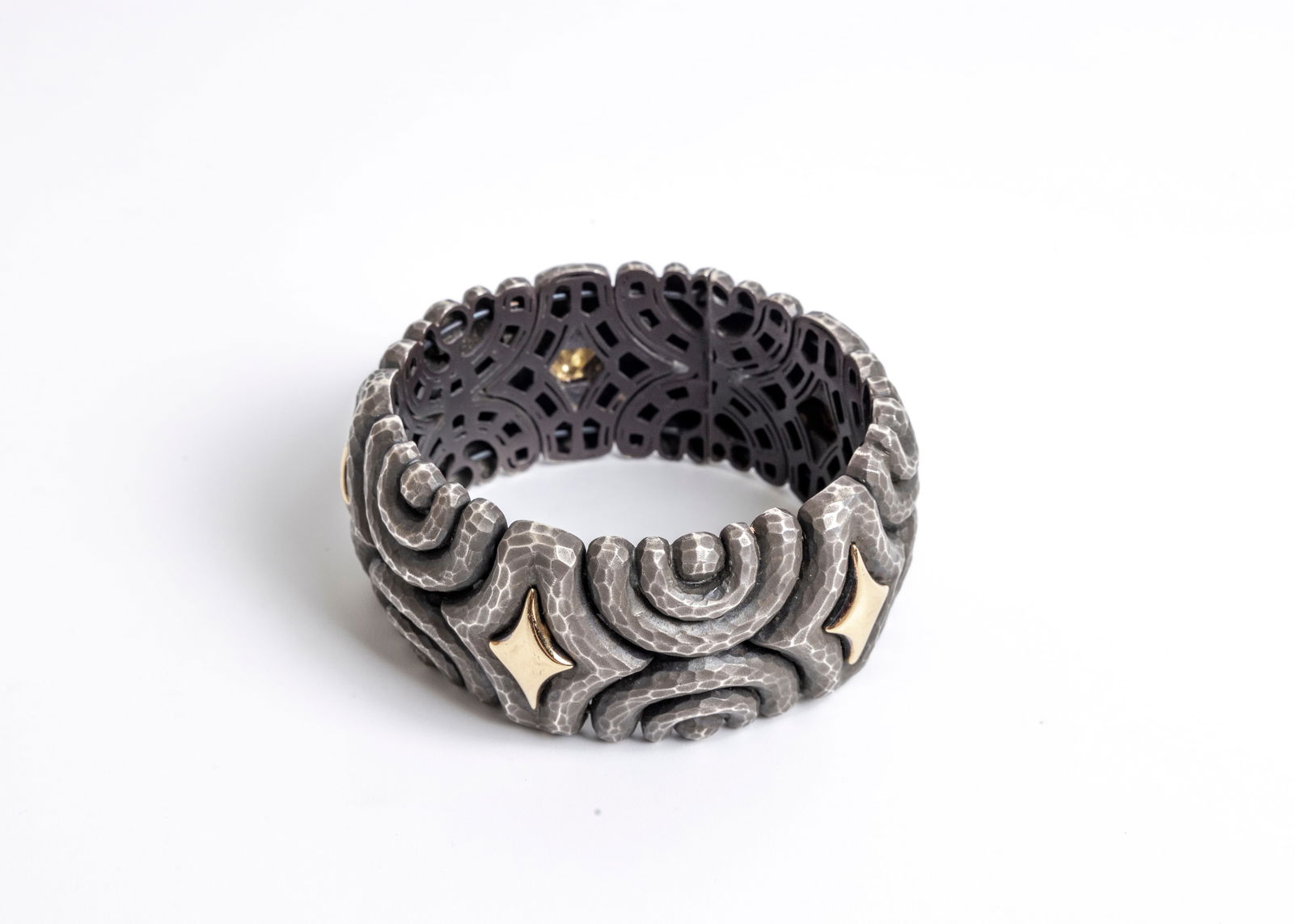 A DORFMAN STERLING SILVER HAND HAMMERED BANGLE BRACELET. With 18K yellow gold diamond shaped center (1 of 6)