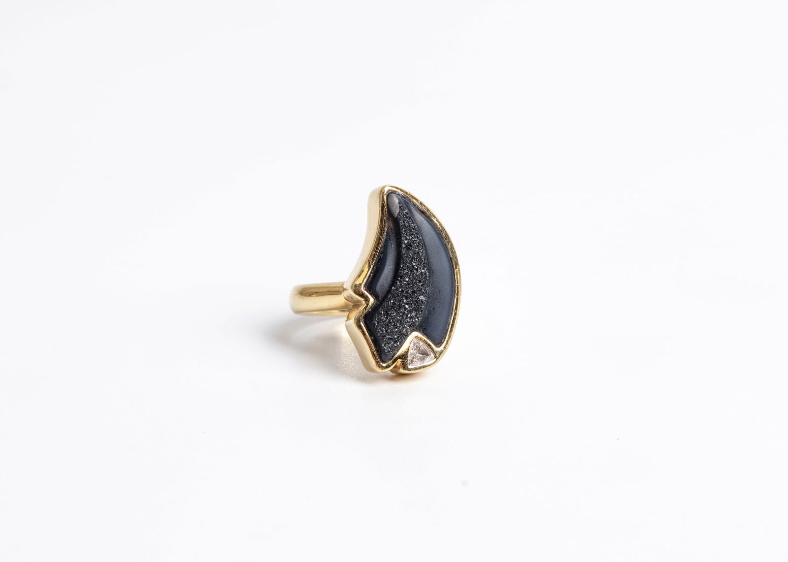 A 18K YELLOW GOLD FREEFORM BLACK DRUZY RING. Accented with one bezel set 0.13 carat trillion cut dia (1 of 6)