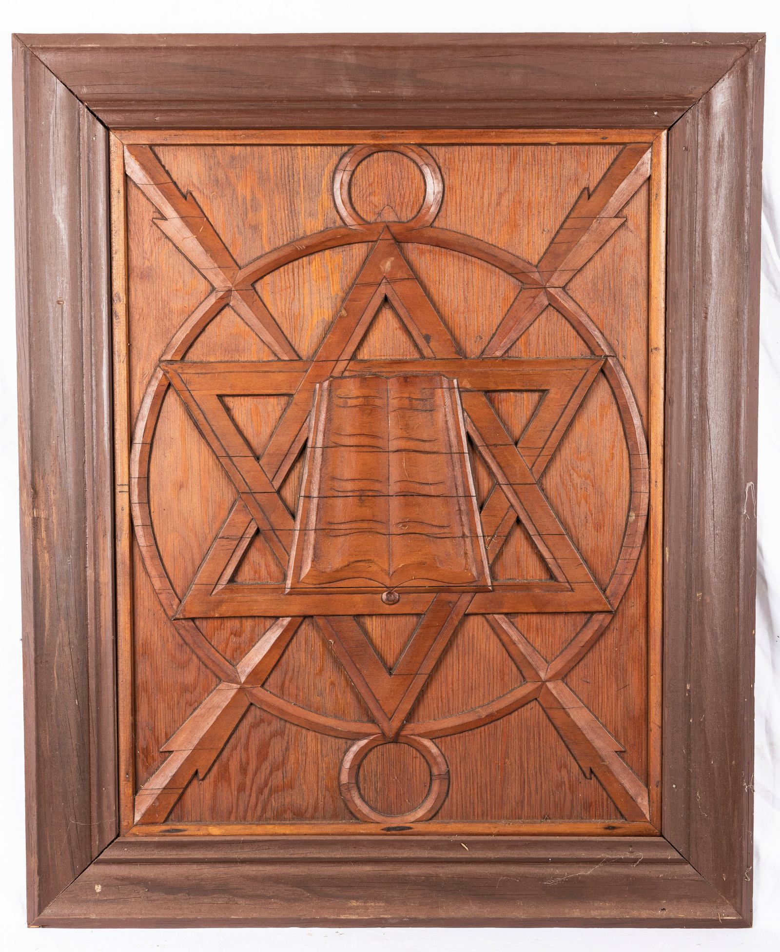 A HAND CARVED WOODEN JEWISH STAR. Probably American, c. 1920. With lightning bolts flashing and a: A HAND CARVED WOODEN JEWISH STAR. Probably American, c. 1920. With lightning bolts flashing and a central open book. 34” x 28”.